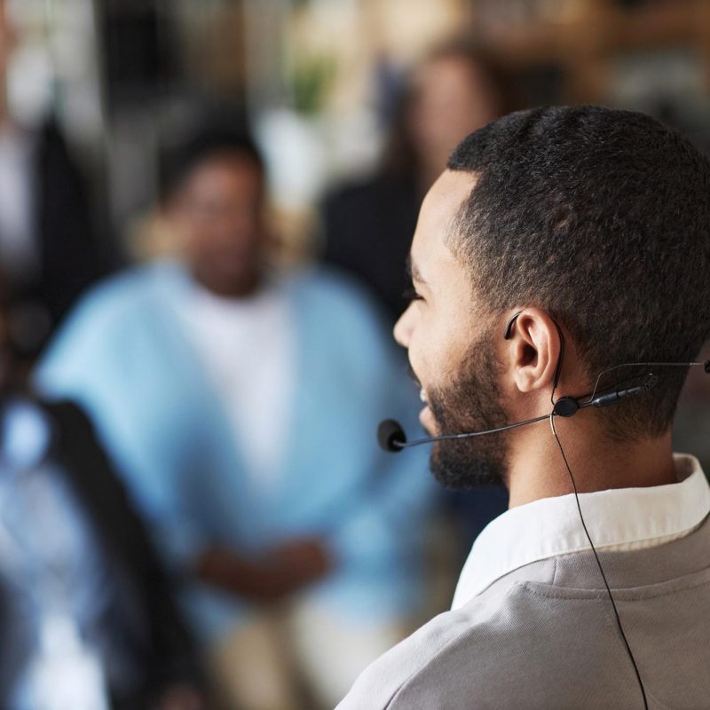 Back view of head of young multiethnic male coach with microphone Back view of head of young multiethnic male coach with microphone